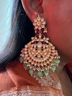 These gorgeous wedding Kundan earrings will add a perfect charm to your occasion wear. You will definitely fall in love with this beauty and it will make you stand out among the crowd. Pachi Kundan Length 9.5cms Width 6 cms Weight 68 grams a pair Luxury Green Chandbali Bridal Earrings, Luxury Green Bollywood Jhumkas, Fusion Style Kundan Dangle Bridal Earrings, Fusion Kundan Pearl Earrings For Wedding, Green Meenakari Bridal Earrings For Reception, Green Chandbali Bridal Earrings For Reception, Kundan Drop Earrings For Wedding Reception, Heavy Bridal Dangle Earrings For Reception, Green Bridal Earrings For Reception On Diwali