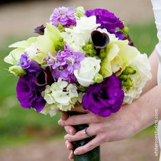 the bride's bouquet has purple and white flowers