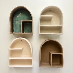 three clay shelves with different shapes and sizes