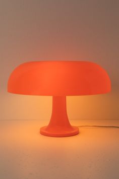 an orange lamp sitting on top of a table