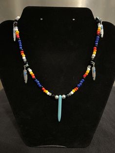 16 in choker style medicine wheel inspired colorful beaded necklace with feather charms and turquoise pendant Southwestern Style Multicolor Necklaces With Dangling Beads, Southwestern Necklaces With Dangling Beads And Adjustable Fit, Southwestern Necklaces With Dangling Beads, Southwestern Necklace With Dangling Beads, Southwestern Necklace With Dangling Beads And Adjustable Fit, Multicolor Southwestern Style Choker, Southwestern Style Multicolor Choker, Colorful Beaded Necklace, Medicine Wheel