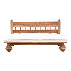 a wooden bench with white cushions on it