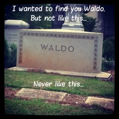 a monument with the words waldo written on it in front of grass and trees