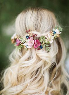 a woman with blonde hair and flowers in her hair