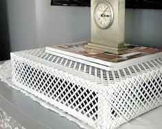 a white wicker table with a clock on top