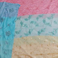 four different colors of fabric with flowers and leaves on them, one is pink, the other is blue