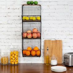 a kitchen table with fruit and vegetables on it, next to a toaster oven