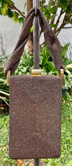 "This is a 1940's brown beaded box purse.  It has a brass frame with a braided beaded handle. Measures   Measures 8\" high, 5\" wide, 2\" wide, 3-3/4\" -bottom, 2-1/4\" width at the top.   Please note there is slight overall wear on the frame, and. a few areas where the thread is showing on the edge (see photos).  In great condition for the age." Beaded Belt, Beaded Boxes, Dress Clip, Vintage Bakelite, Brass Frame, Blue Stone, Turquoise Stone, Purses And Bags, Craft Supplies