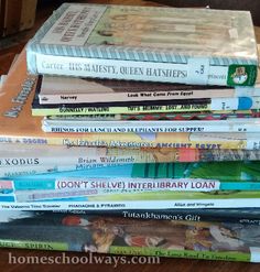 a stack of books sitting on top of a wooden table