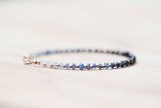 This sweet, simple beaded bracelet features faceted blue sapphire rondelles that range from light to dark and back again, spaced by round gold filled beads. Finished with a gold-filled lobster clasp and findings. Another great piece for wearing alone, or stacking up with an armful of your favorite pretties! Also available with rose gold filled or sterling silver instead of gold components... please make your selection from the drop-down menu. Sapphire is the birthstone for September. This is a f Dainty Blue Beaded Bracelets With Faceted Beads, Elegant Handmade Sapphire Bracelets, Gift Sapphire Beaded Bracelets With Faceted Beads, Blue Faceted Rondelle Bracelets, Sapphire Round Faceted Bead Bracelets, Dainty Blue Bracelets With Faceted Beads, Dainty Blue Faceted Beaded Bracelets, Adjustable Faceted Sapphire Bracelets, Hand-strung Sapphire Beaded Bracelets