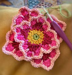 a crocheted flower is shown on the pillow