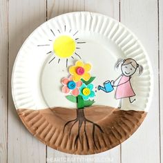 a paper plate with a child's drawing on it and a tree in the middle