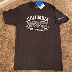 Columbia Shirt Small New With Tags Heathered Dark Gray With White Columbia Sportswear Co. And Rope Decal On Front. White Columbia On Left Sleeve 50% Cotton / 50% Polyester Smoke Free, Pet Free Home Casual Tops For Outdoor Sports Season, Casual Tops For Outdoor Sports, Sporty Tops With Logo Print For Outdoor, Casual Logo Print Tops For Outdoor, Casual Tops With Logo Print For Outdoor, Casual Outdoor Tops With Logo Print, Columbia Shirt, Columbia Sportswear, Shirt Color