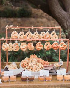 a table topped with lots of doughnuts and other food on top of it