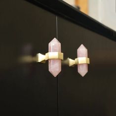 the door handles are made out of brass and pink quartz stone with gold trimmings