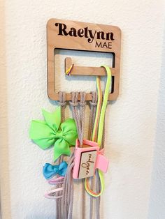 Need a baby shower gift or a sweet gift for a girl ? This is the perfect way to help organize the nursery with baby bows and headbands.  THINGS TO KNOW/DETAILS OPTIONS:  This option of our bow hanger comes engraved only. It is about 4.5inx4.5in and is about 16 inches long with the macrame. It is a perfect way to hang hair ties, headbands, bows, clips and more!  We also love custom orders so if you would like a different variation of this item or a customization of this item please send us a message and we would be happy to help! IMPORTANT SHIPPING INFORMATION Our turnaround time for receiving your item is about 1-2 weeks. We typically use USPS for smaller items and UPS for our larger/heavier items. If you need your item sooner, we offer two ways to rush your item at an additional charge. W Hair Accessory Organizer, Hair Clip Organizer, Hair Tie Holder, Clip Organizer, Bow Storage, Hair Bow Organizer, Tie Holder, Headband Organizer, Accessory Organizer