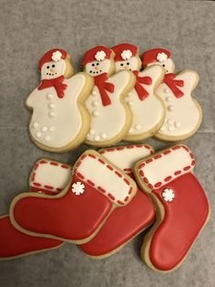 decorated cookies in the shape of christmas stockings and snowmen with red stocking caps