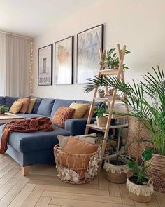 a living room filled with furniture and plants