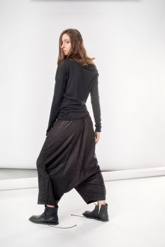 "Structured yet flowing, these black melange wool pants are a match made in heaven: the extremely low drop bottom, the manly back pocket and the side pleat pay homage to both masculine trousers and feminine long skirts to create an year-round wardrobe essential that will win you over with its understated eccentricity and unmatched comfort. We add a final touch to everything you buy from us by wrapping it in our reusable signature black canvas zip bag. Enjoy! Our wonderful model has these measure Black Linen Pants, Drop Crotch Pants, Lovely Tops, Wool Trousers, Zipped Bag, Wool Pants, Rompers Women, Long Skirt, Wardrobe Essentials