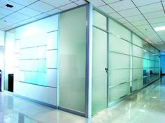 an empty room with glass partitions in the middle