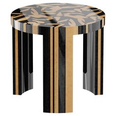 an artistically designed table with black, gold and silver stripes on the bottom half