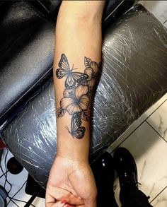 a woman's arm with a butterfly tattoo on it