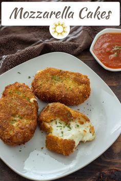 three fried food items on a white plate next to sauces and a napkin with a brown towel