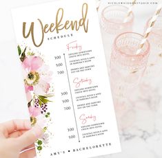 a person holding up a menu for a bachelor party with pink flowers and gold lettering