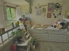 a bed room with a neatly made bed and lots of pictures hanging on the wall