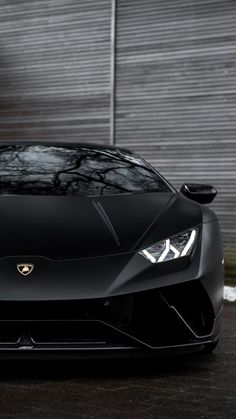 a black sports car parked in front of a building