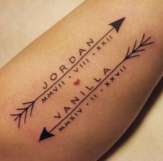 a woman's arm with an arrow tattoo on it