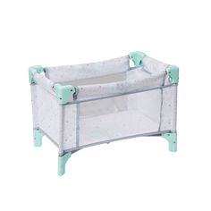 a white baby crib with green handles