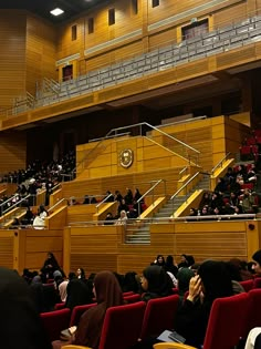 an auditorium with people sitting in the seats