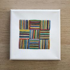 a small square with multicolored squares on it