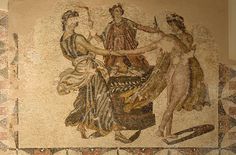 an old mosaic with two women on it's sides and one woman holding the arm of another woman