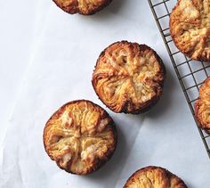 four pastries sitting on top of a cooling rack next to a yellow sticker that says subscribe to bon appetit