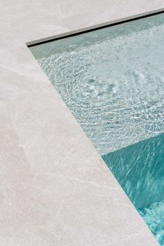 an empty swimming pool with clear blue water