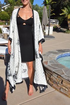 Enjoy summer in this beautiful silk white and black kimono. Dressy or casual . Not a sheer fabric. Medium weight silk. One size. The width is 52 inches when closed. The length is 50 inches. White V-neck Kimono For Day Out, Silk Long Kimono For Beach Cover-up, Silk Wrap Kimono For Vacation, Black Long Kimono For Beach Cover-up, White Silk Kimono For Summer, Chic White Kimono For Beach Cover-up, Summer White Silk Kimono, White Beachwear Kimono For Day Out, Elegant Summer Daywear Kimono