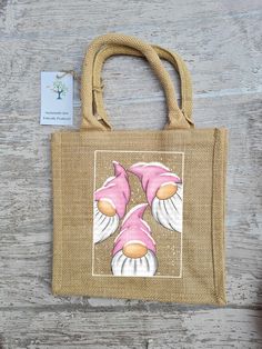 a jute bag with an image of a pink fish on it's side