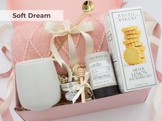 a pink box filled with lots of different items next to a white cup and spoon