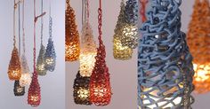 several different colored lights hanging from chains