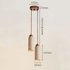 three lights hanging from the ceiling with measurements