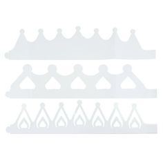 four white plastic crowns on a white background