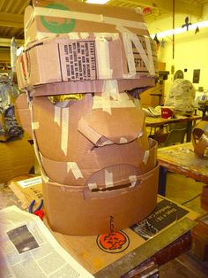 a large cardboard sculpture sitting on top of a wooden table