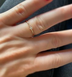 a woman's hand with a ring on it