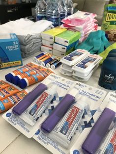 the contents of an emergency kit laid out on a table with water bottles and other medical supplies