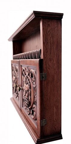 an intricately carved wooden cabinet with two doors on the front and one door open