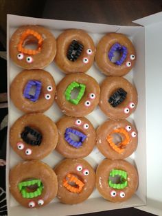 a box filled with donuts decorated like monsters