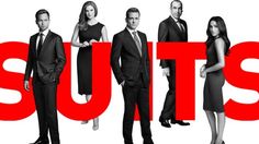 a group of people standing in front of the word suits on a white background with red letters