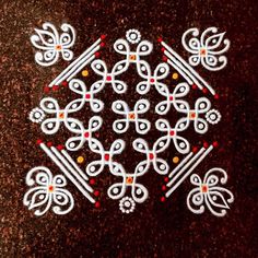 an intricately designed design on the ground in white and red colors, with small dots